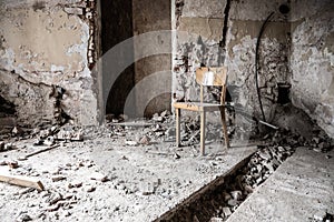 Old wooden chair in devasted abandoned room