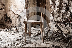 Old wooden chair in devasted abandoned room