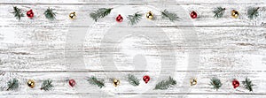 Old wooden Christmas background. Fir branches. Gold and red baubles. Christmas card. Top view. Space for your text.