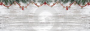 Old wooden Christmas background. Fir branches. Gold and red baubles. Red garlands. Xmas card. Top view. Space for your text.