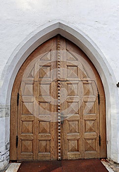 Old wooden church arch door exterior in old european city