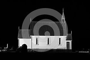 Old wooden church building at night. Black and white