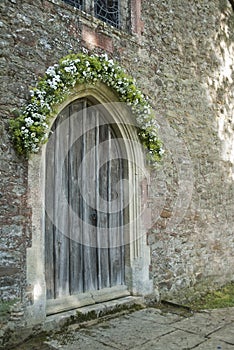 Old Wooden Church Door with Daisy Bouquet