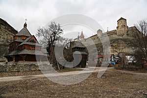 Old wooden church and old castle in Kamianets-Podilskyi city, we