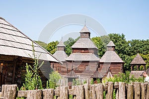 Old wooden church and village cottage folk architecture in Pyrohiv, Ukraine