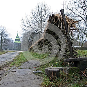 Old wooden church and wicker fence in the village