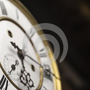 Old wooden clock with a pendulum hanging