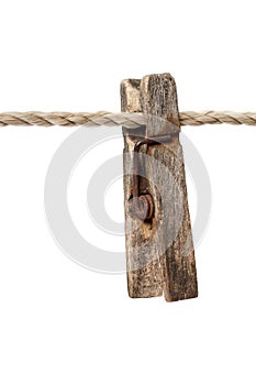 An old wooden clothespin on a rope.