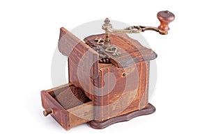 Old wooden coffee grinder with coffee beans