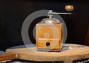 old wooden coffee grinder to pulverize the beans and prepare the drink with drawer