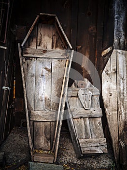 Old wooden coffins leaning in a shed