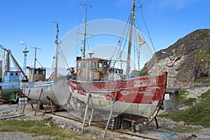 Old wooden colorful boats with peeling paint in wharf, Greenland