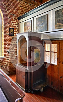 Old wooden confessional box in a church