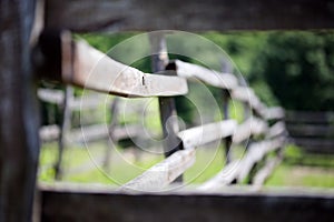 Old wooden corral fence in meadow rural scene bokeh mood