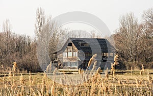 Old wooden cottage in scenic wetland landsape of nature reserve of river mouth Isonzo