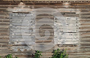 Old wooden country house with boarded up windows