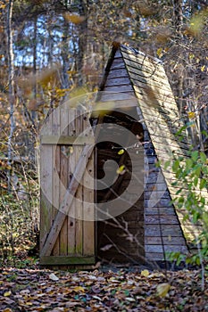 old wooden countryside toilet house with heart shaped hole in th