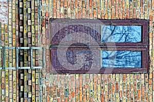 Old wooden covered door on a brick wall with a staircase