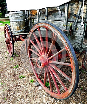 Old Wooden Covered Wagon and water barrel.