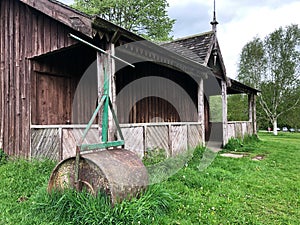 An old English cricket pavilion with roller