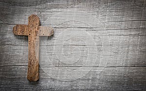 Old and wooden cross on a background