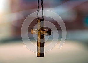 Old wooden cross on a thread