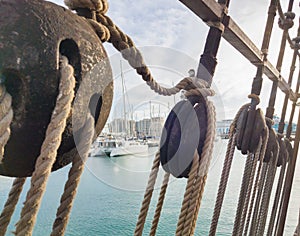 Old wooden deadeye on the shrouds of a sailing vessel of the eighteenth century