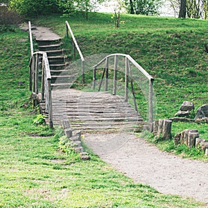 Old wooden decorative bridge in the park. square