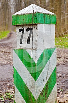 Old, wooden, demarcation, border sign, set in the woods photo