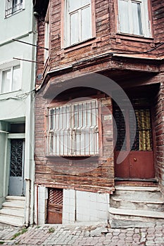 An old wooden destroyed building with a bay window