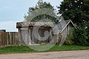 Old wooden dilapidated village house with gate