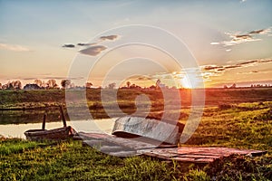 Old wooden dock with boats at sunset