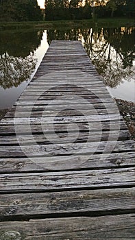 Old wooden dock on pond