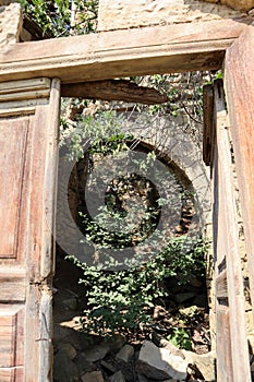 Old wooden door in abandoned ruined house in ancient village Gamsutl, Dagestan