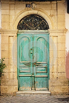 Old wooden door in ancient greek house. Crete