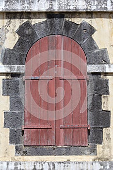Old wooden door in a brick archway. Close up