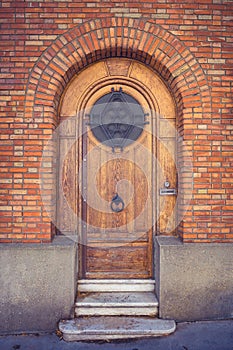 Old wooden door in brick wall