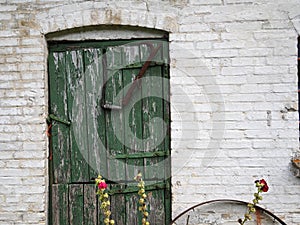 Old wooden door on a bricks house