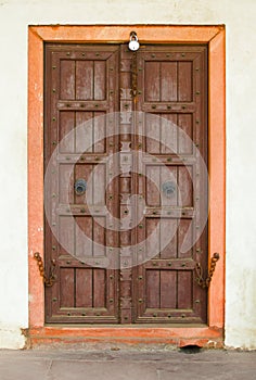 Old wooden door on a building facade. India, Agra