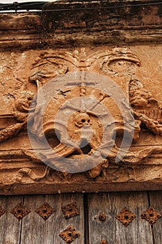 Old wooden door and coat of arms of the Holy Inquisition photo