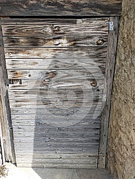 Old wooden door of a country farm in Italy.