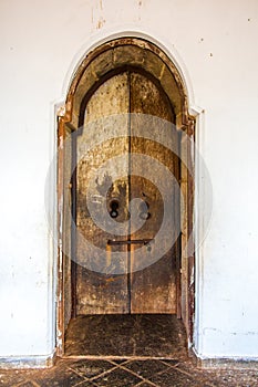 Old wooden door in Dambulla buddhist cave temple complex in Sri