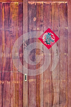 Old wooden door decorated Chinese New Year couplet