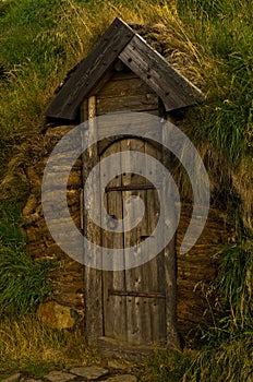 Old wooden door, a detail from reconstructed house of famous viking Erik the Red at Eirikstadir