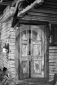Old wooden door in a deteriorated building
