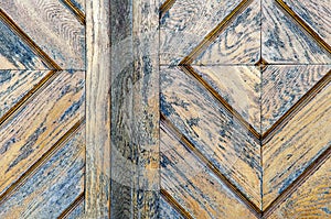 old wooden door diamond shape. shabby red paint with cracks. entrance to the ancient church. Texture of wood closeup