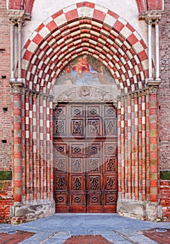 Old wooden door at the entrance to catholic church.