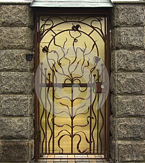 Old wooden door with forged hinges, wooden texture of old doors with forging elements