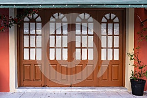 Old wooden door with glass windows in old town in Europe. Entrance of house with arched wooden door and transom window