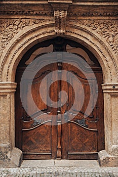 Old wooden door made of solid dark oak. Europe style